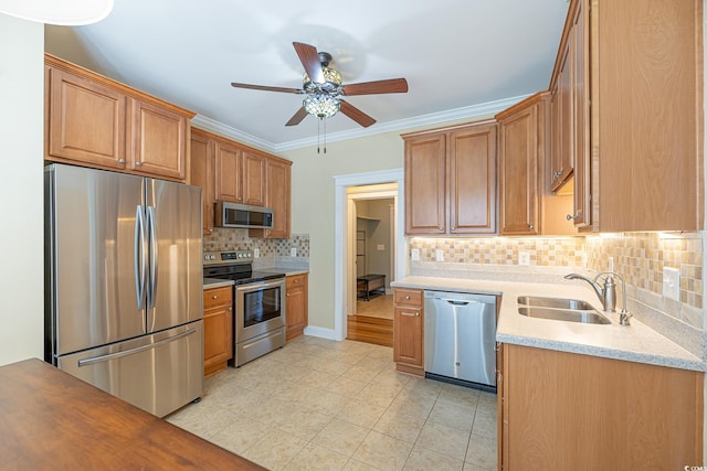 kitchen with sink, light tile patterned floors, ornamental molding, stainless steel appliances, and decorative backsplash