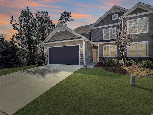 craftsman house featuring a yard and a garage