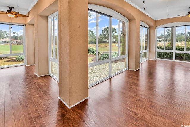 unfurnished sunroom with ceiling fan and a healthy amount of sunlight