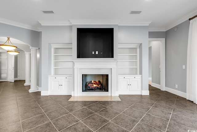 unfurnished living room featuring decorative columns, crown molding, and dark tile patterned flooring