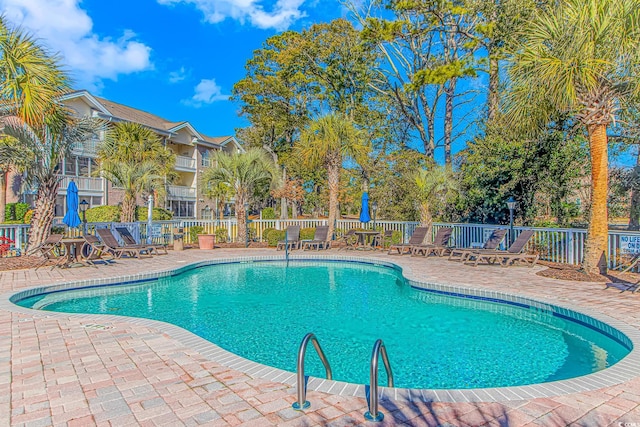 view of swimming pool featuring a patio area