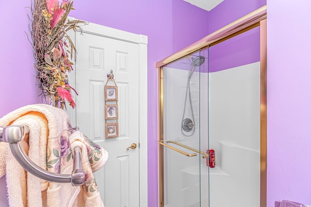 bathroom featuring a shower with door