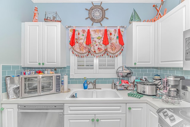 kitchen featuring white cabinetry, dishwasher, sink, decorative backsplash, and stove