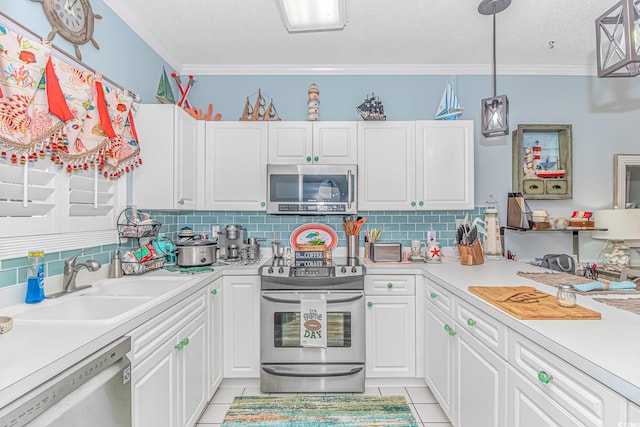 kitchen with sink, white cabinetry, light tile patterned floors, pendant lighting, and stainless steel appliances