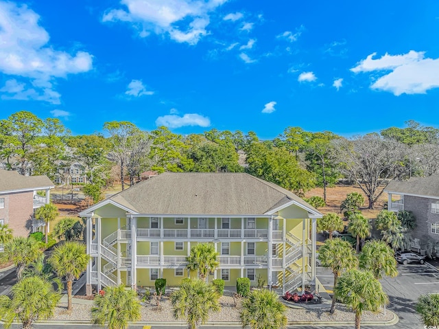 rear view of property featuring a balcony