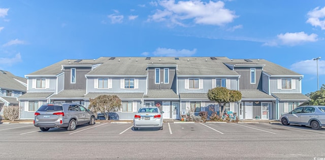 view of property with a residential view and uncovered parking