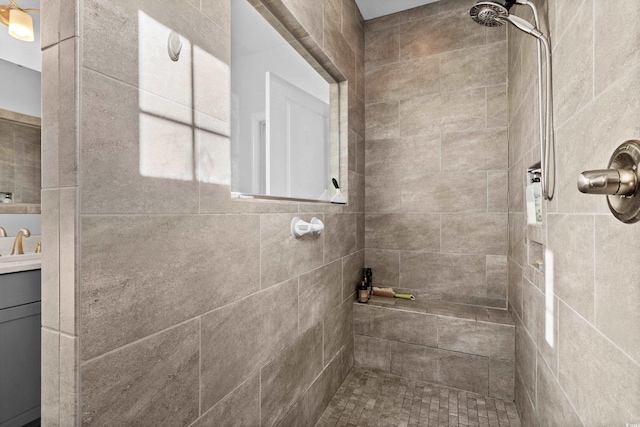 bathroom featuring vanity and tiled shower