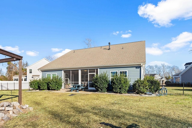 back of house featuring a yard and a sunroom