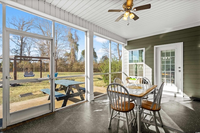 sunroom / solarium featuring ceiling fan