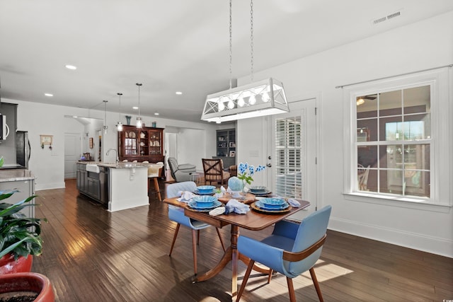 dining room with dark wood-type flooring and sink