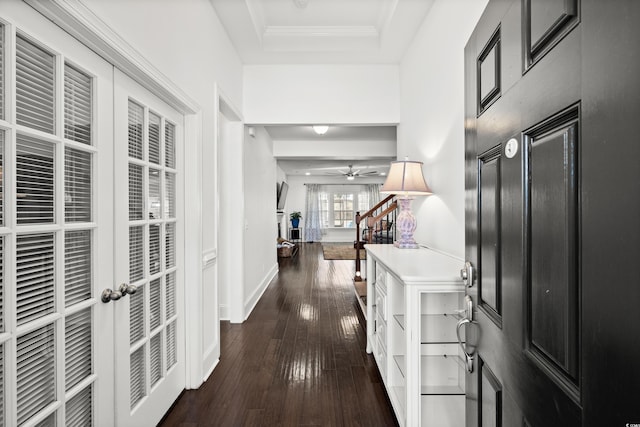 hall with french doors, ornamental molding, dark hardwood / wood-style floors, and a tray ceiling