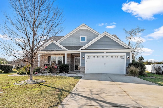 craftsman inspired home with a garage and a front lawn