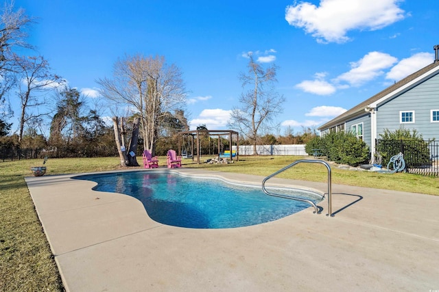 view of pool with a lawn and a patio