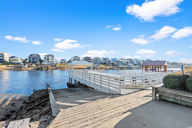 view of dock featuring a gazebo and a water view