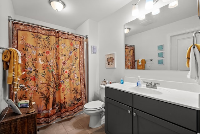 bathroom with vanity, toilet, and tile patterned flooring