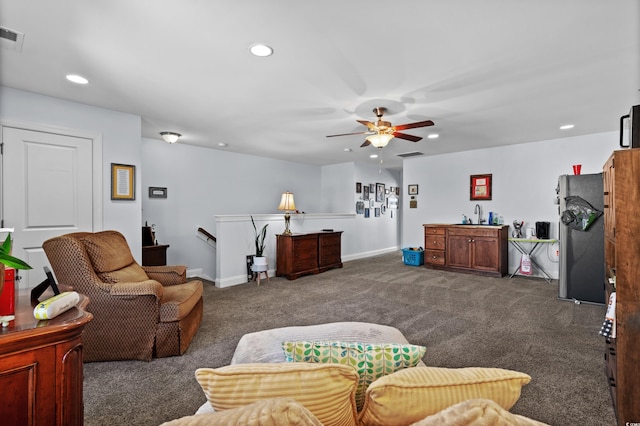 living room with ceiling fan and dark carpet