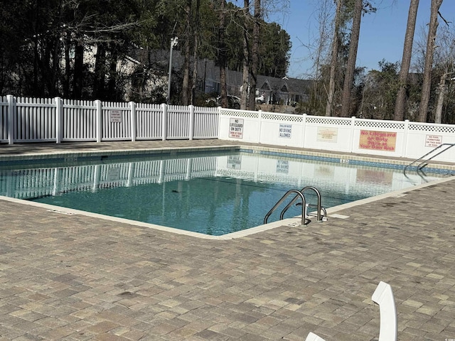 pool featuring a patio and fence
