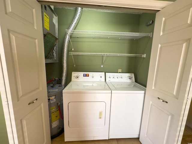 washroom with water heater and separate washer and dryer