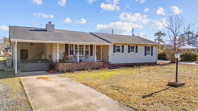 ranch-style home featuring a carport, covered porch, and a front yard