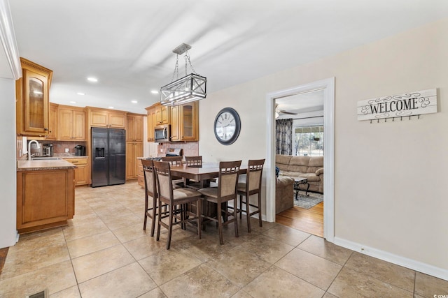 tiled dining room featuring sink