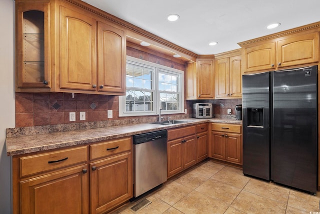 kitchen with tasteful backsplash, appliances with stainless steel finishes, sink, and light tile patterned floors