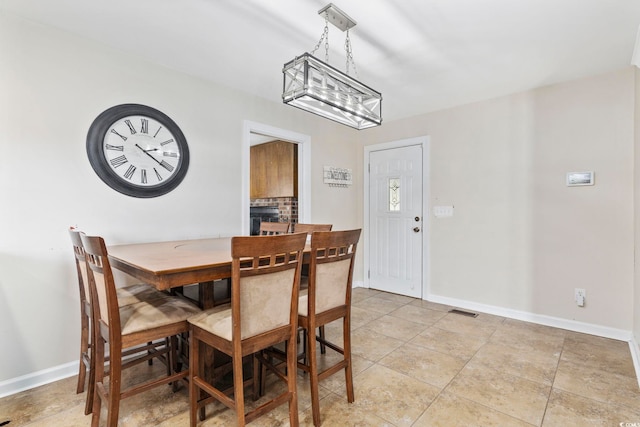 tiled dining area featuring a fireplace