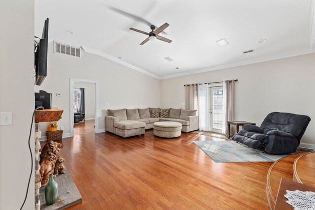 living room featuring hardwood / wood-style flooring, crown molding, vaulted ceiling, and ceiling fan