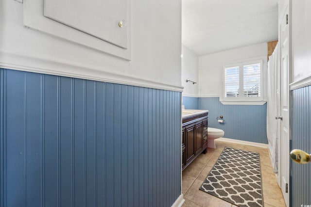 bathroom with tile patterned flooring, vanity, and toilet