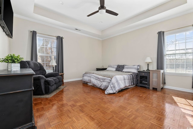 bedroom featuring ornamental molding, parquet flooring, and a tray ceiling