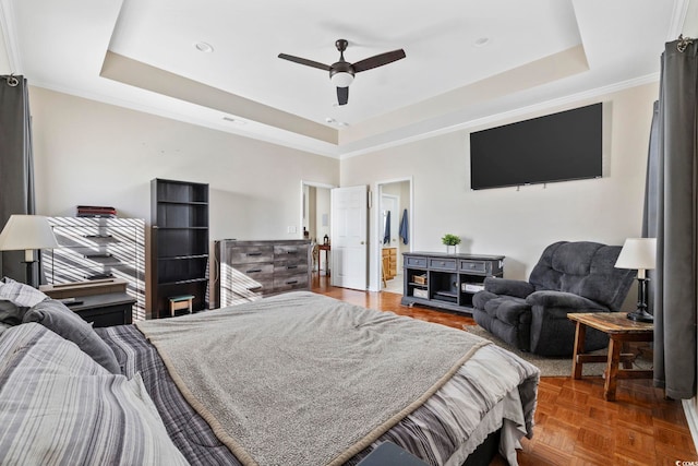 bedroom featuring a tray ceiling, parquet flooring, and ceiling fan