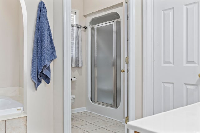 bathroom with tile patterned flooring and a shower with door