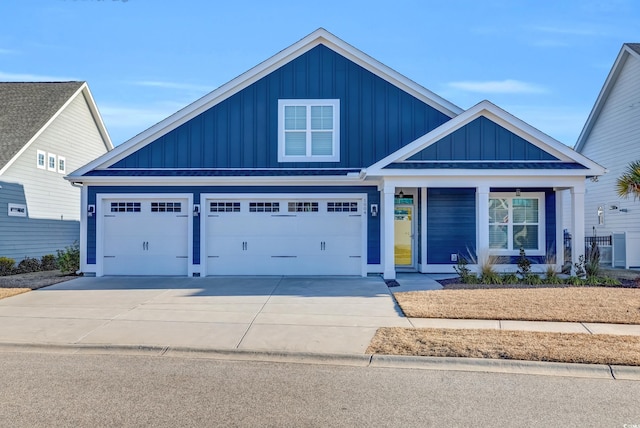 view of front of home featuring covered porch, driveway, and board and batten siding