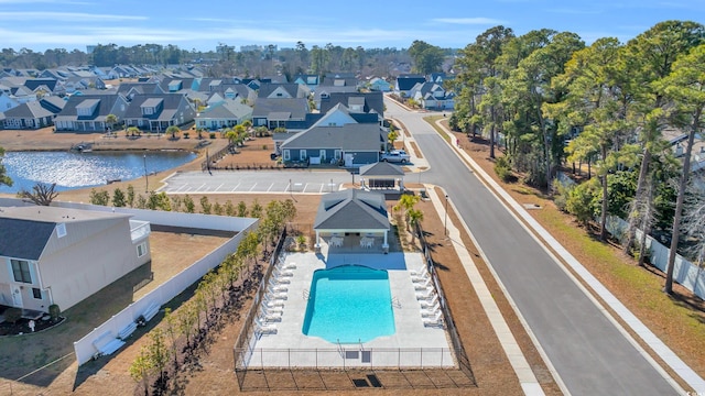 drone / aerial view with a water view and a residential view