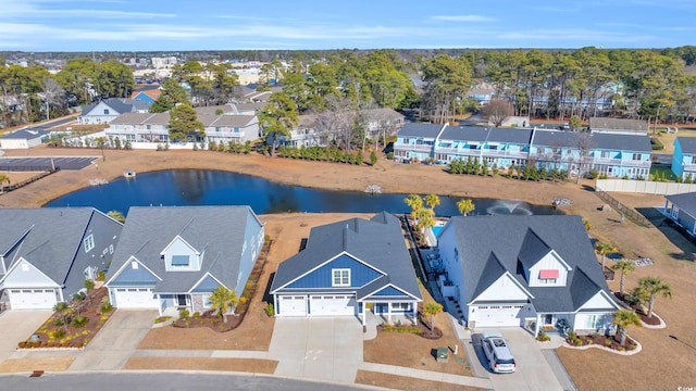 drone / aerial view featuring a water view and a residential view
