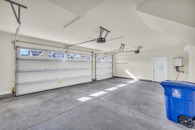 garage featuring baseboards, tankless water heater, and a garage door opener