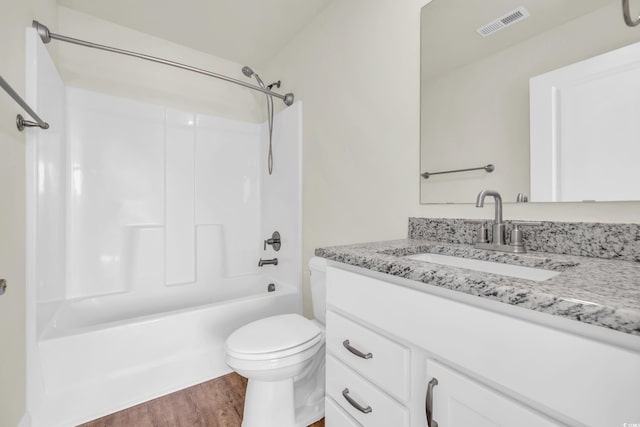 bathroom with shower / bathtub combination, toilet, wood finished floors, vanity, and visible vents