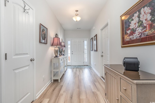 foyer entrance with light hardwood / wood-style flooring