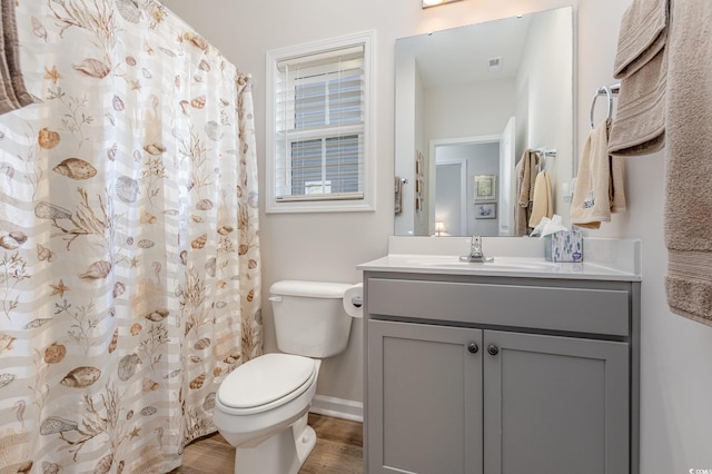 bathroom featuring vanity, hardwood / wood-style floors, and toilet