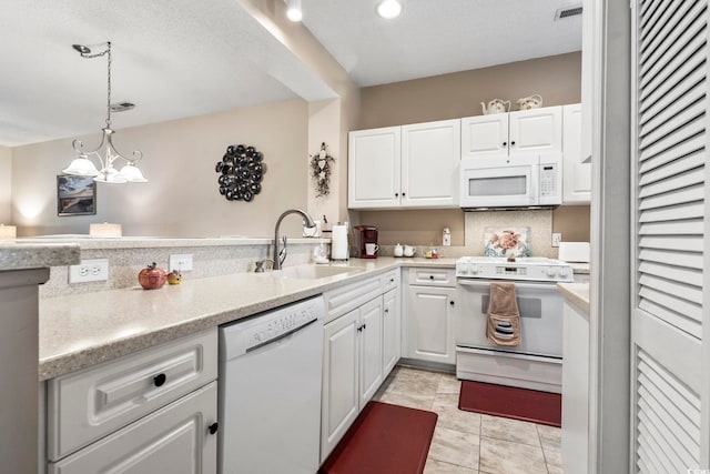 kitchen with sink, decorative light fixtures, a notable chandelier, white appliances, and white cabinets