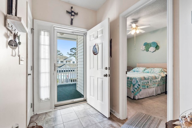 entryway with light colored carpet and ceiling fan