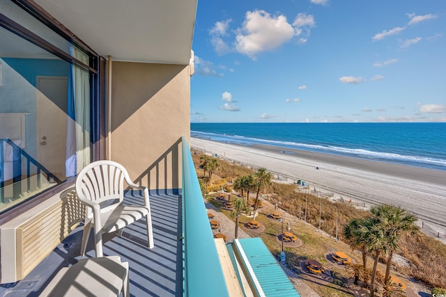 balcony featuring a beach view and a water view