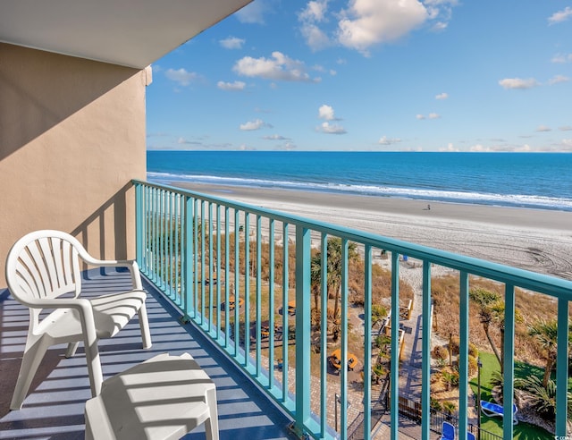 balcony with a view of the beach and a water view