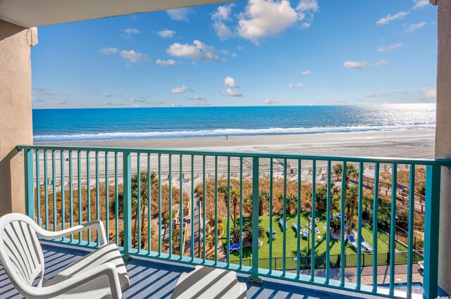 balcony with a view of the beach and a water view