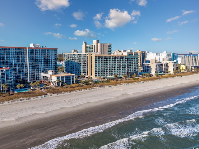 bird's eye view with a water view and a beach view