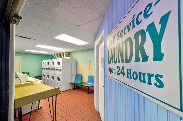 kitchen with a paneled ceiling, tile patterned floors, washer and dryer, and stacked washer and dryer