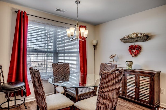 dining room featuring a chandelier and light wood-type flooring