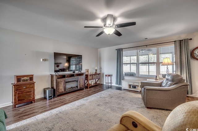 living room featuring hardwood / wood-style floors and ceiling fan