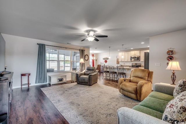 living room with hardwood / wood-style flooring and ceiling fan