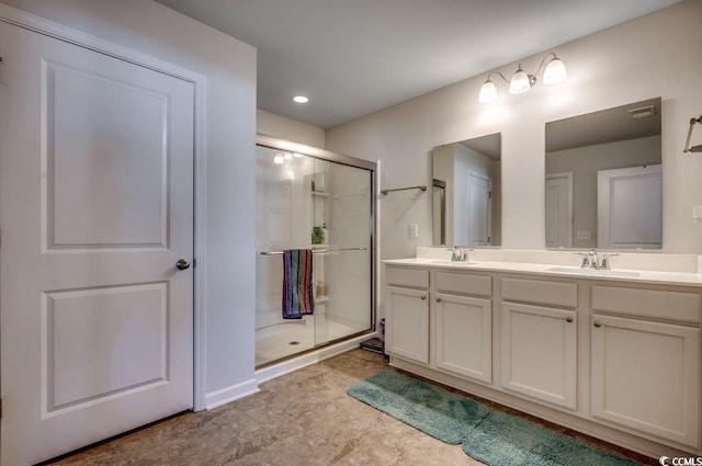 bathroom with vanity and a shower with shower door