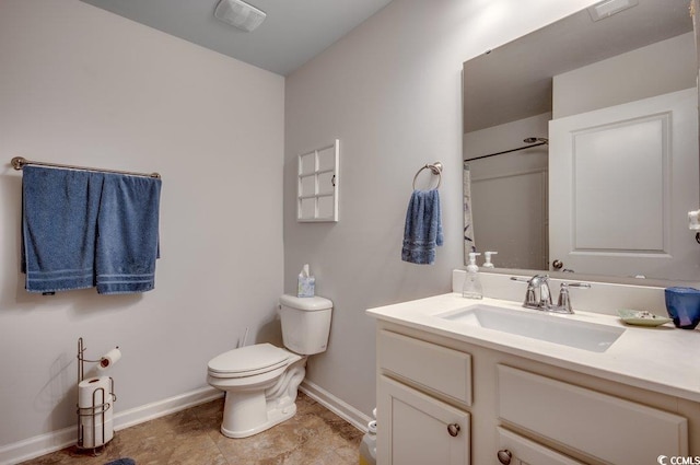 bathroom featuring vanity, toilet, and walk in shower